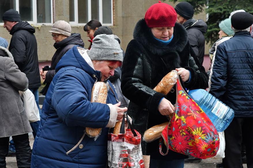 Women receive bread at a humanitarian aid distribution point in Kramatorsk.