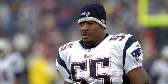 New England Patriots linebacker Willie McGinest stands on the sideline during a game against the Buffalo Bills at Ralph Wilson Stadium in Orchard Park, New York, on Dec. 11, 2005.