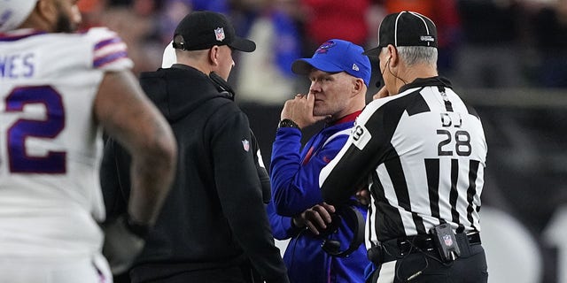 Head coach Sean McDermott of the Buffalo Bills and head coach Zac Taylor of the Cincinnati Bengals speak during the suspension of their game following the injury of Damar Hamlin #3 of the Buffalo Bills at Paycor Stadium on January 02, 2023 in Cincinnati, Ohio.