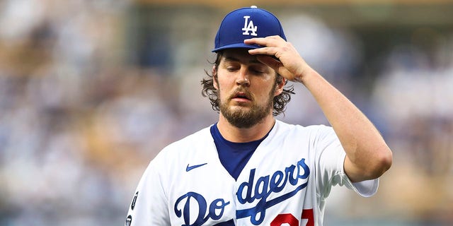 Trevor Bauer of the Los Angeles Dodgers returns to the dugout after the top of the first inning against the San Francisco Giants at Dodger Stadium June 28, 2021, in Los Angeles. 