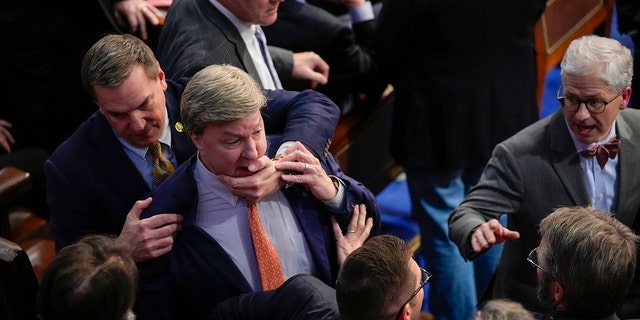 Rep. Richard Hudson, R-N.C., left, pulling Rep. Mike Rogers, R-Ala., back as they talk with Rep. Matt Gaetz, R-Fla., and other during the 14th round of voting for speaker as the House met for the fourth day to try and elect a speaker and convene the 118th Congress in Washington, Friday, Jan. 6, 2023. At right is Rep. Patrick McHenry, R-N.C. 