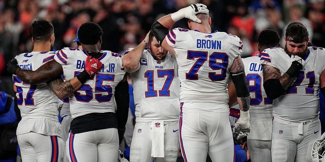 Jan 2, 2023; Cincinnati, Ohio, USA; The Buffalo Bills gather as an ambulance parks on the field while CPR is administered to Buffalo Bills safety Damar Hamlin (3) after a play in the first quarter of the NFL Week 17 game between the Cincinnati Bengals and the Buffalo Bills at Paycor Stadium in Downtown Cincinnati. The game was suspended with suspended in the first quarter after Buffalo Bills safety Damar Hamlin (3) was taken away in an ambulance following a play. 