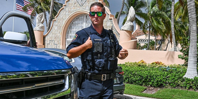 Local law enforcement officers are seen in front of the home of former President Donald Trump at Mar-a-Lago in Palm Beach, Florida, on Aug. 9, 2022.