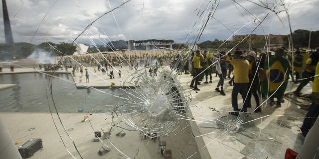 Supporters of former President Jair Bolsonaro clash with security forces as they break into Planalto Palace and raid the Supreme Court in Brasilia, Brazil, on Jan. 8, 2023.