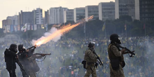 Supporters of former President Jair Bolsonaro clash with security forces as they raid the National Congress in Brasilia, Brazil, on Jan. 8, 2023.