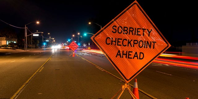 A sign warning of an upcoming DUI checkpoint is seen on an interstate.