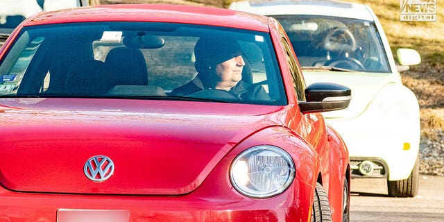 A man who appears to be Brian Walshe drives away from his home at 516 Chief Justice Cushing Highway, Cohasset, Mass. He is in a friend or relative's car. Law enforcement appeared to have moved the family out of the house to investigate its contents.