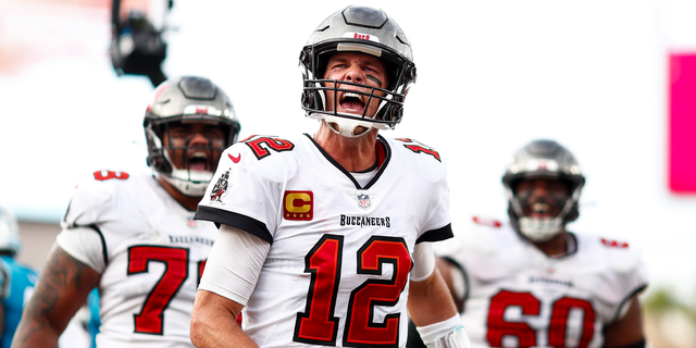 Quarterback Tom Brady of the Tampa Bay Buccaneers screams in celebration after rushing for a touchdown during the fourth quarter of an NFL game against the Carolina Panthers at Raymond James Stadium in Tampa, Florida, on Jan. 1.