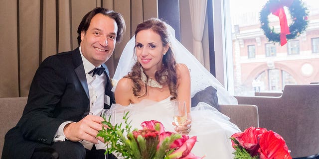 Brian and Ana Walshe raise a toast on their wedding day in the lounge of L'Espalier in Boston on Dec. 21, 2015.