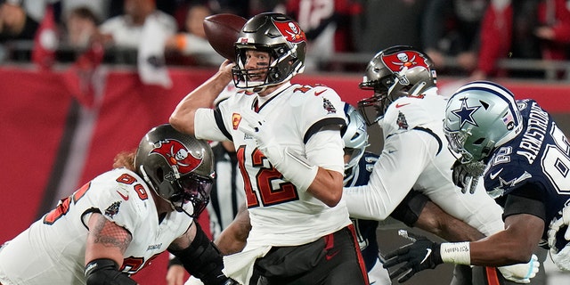 Tampa Bay Buccaneers quarterback Tom Brady (12) works under pressure against Dallas Cowboys during the first half of an NFL wild-card football game, Monday, Jan. 16, 2023, in Tampa, Fla.