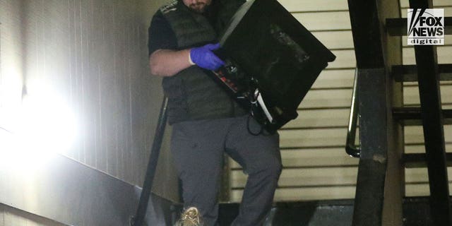 Investigators search Bryan Christopher Kohberger's home in Pullman, WA after dark on December 30, 2022. Among the items removed was the desktop computer, several boxes of evidence and multiple bags.