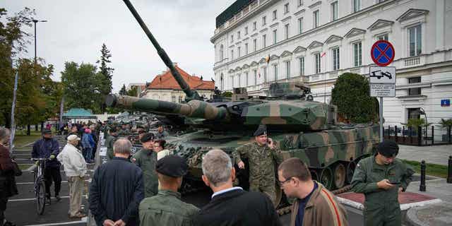 A Leopard 2 tank of the Polish Army is seen with a soldier in camouflage near Pilsudski Square in Warsaw, Poland on 13 September, 2022. (Photo by STR/NurPhoto via Getty Images)