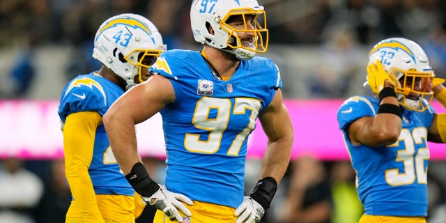 Los Angeles Chargers defensive end Joey Bosa (97) waits at the line with cornerback Michael Davis (43) and safety Alohi Gilman (32) during the first half against the Las Vegas Raiders at SoFi Stadium Oct. 4, 2021, in Inglewood, Calif. 