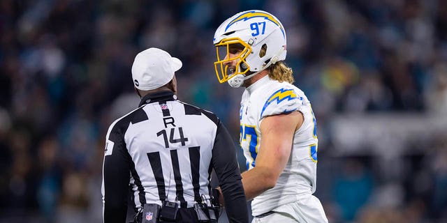 Los Angeles Chargers linebacker Joey Bosa talks with NFL referee Shawn Smith in a game against the Jacksonville Jaguars during a wild-card playoff game at TIAA Bank Field. 