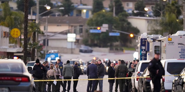 Law enforcement personnel gather outside a ballroom dance club in Monterey Park, Calif., Sunday, Jan. 22, 2023.