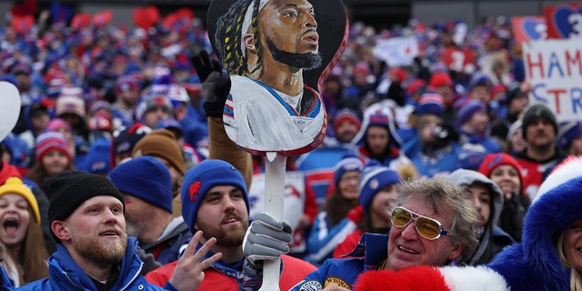 Buffalo Bills fans hold a picture of Damar Hamlin (3) during game vs. New England Patriots at Highmark Stadium. Buffalo.