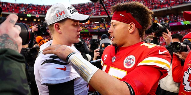 Joe Burrow, #9 of the Cincinnati Bengals, hugs Patrick Mahomes, #15 of the Kansas City Chiefs, after the AFC Championship Game at GEHA Field at Arrowhead Stadium on January 30, 2022, in Kansas City, Missouri.