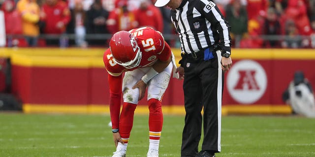 Kansas City Chiefs quarterback Patrick Mahomes holds his ankle in pain in the first quarter of an AFC divisional playoff game against the Jacksonville Jaguars Jan. 21, 2023, at GEHA Field at Arrowhead Stadium in Kansas City, Mo.