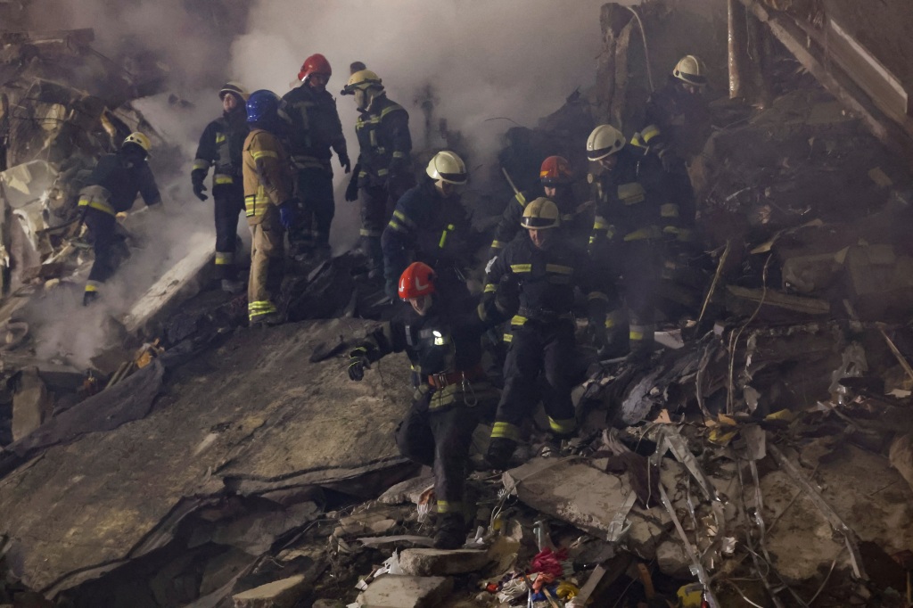 Emergency personnel at the site in Dnipro search for survivors on Jan. 15, 2023.