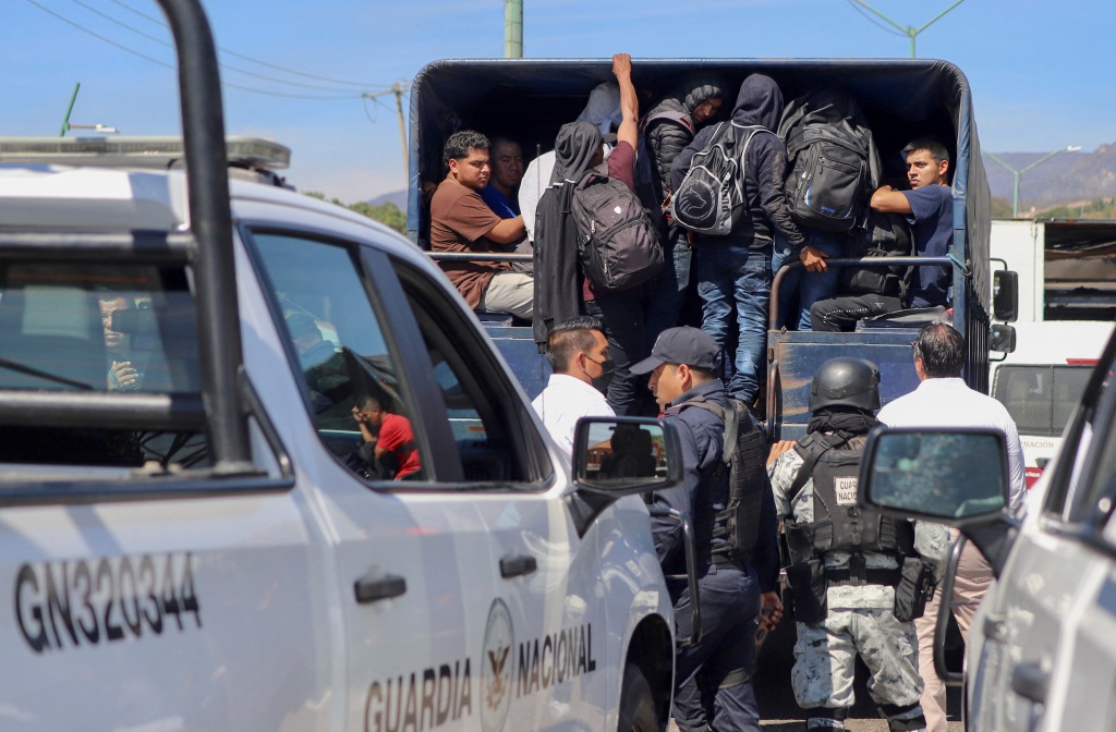Migrants board a vehicle of the Mexican Institute of Migration (INM) after being detected at a checkpoint in Chiapa de Corzo, in Chiapas state, Mexico on Jan. 18, 2023. 