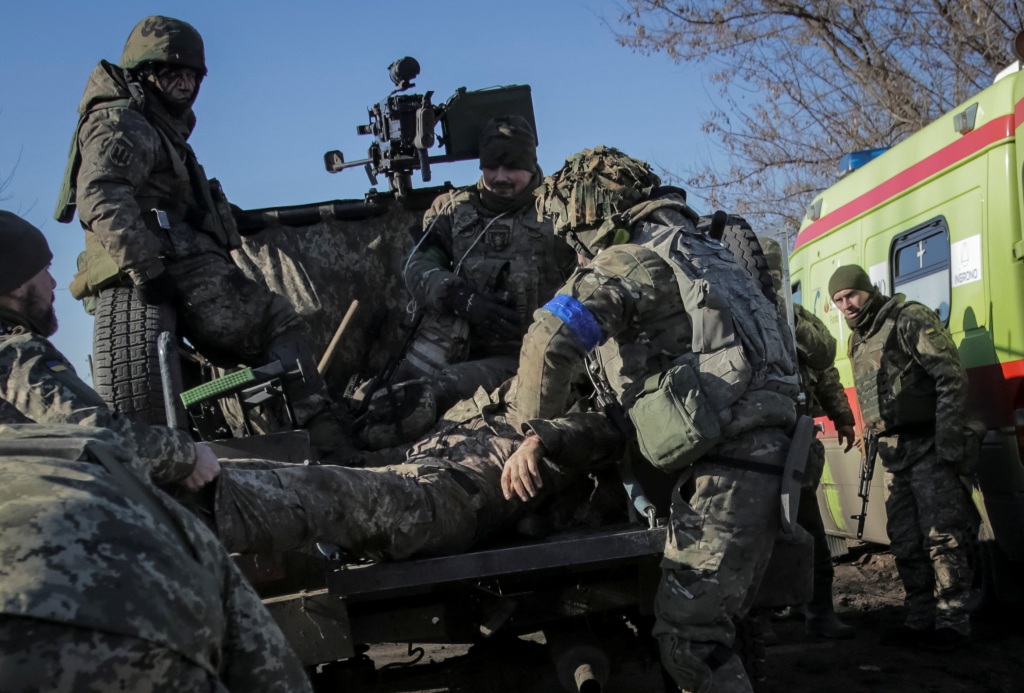 Ukrainian servicemen evacuate their brothers-in-arms who were wounded during shelling at the frontline on Jan. 23, 2023.