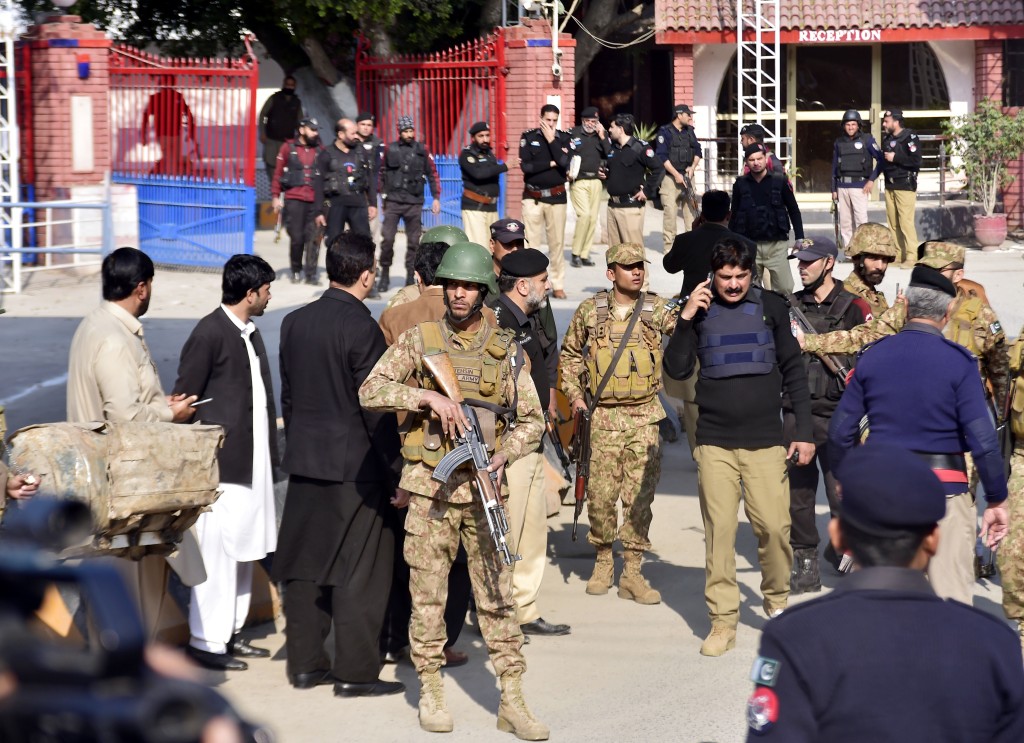 Security personnel stand guard at the blast site in northwest Pakistan's Peshawar on Jan. 30, 2023. 