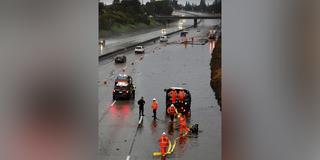 The three right lanes of traffic on westbound 580 near 35th Avenue are blocked while crews try to clear the roadway of major flooding as a strong atmospheric river moves over Oakland, California.