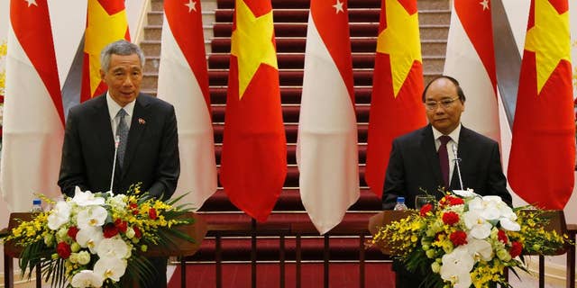 Singapore Prime Minister Lee Hsien Loong, left, speaks during a joint press briefing with his Vietnamese counterpart Nguyen Xuan Phuc in Hanoi, Vietnam, Thursday, March 23, 2017.