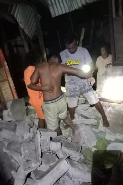 Villagers help a man hit by a fallen wall after the 7.6-magnitude earthquake hit deep under the ocean off Indonesia and East Timor on Jan. 10, 2023.