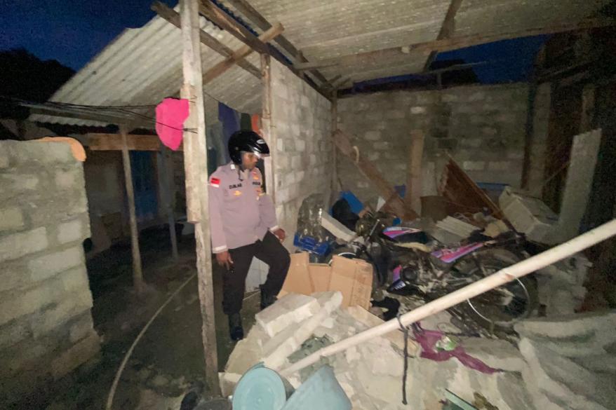 A police officer checks a damaged house after a 7.6-magnitude earthquake hit deep under the ocean off Indonesia and East Timor, in Saumlaki in the Tanimbar Islands Regency on Jan. 10, 2023.