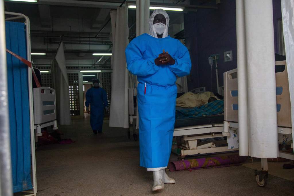 A member of the Ugandan Medical staff of the Ebola Treatment Unit stands inside the ward in Personal Protective Equipment (PPE) at Mubende Regional Referral Hospital in Uganda. 