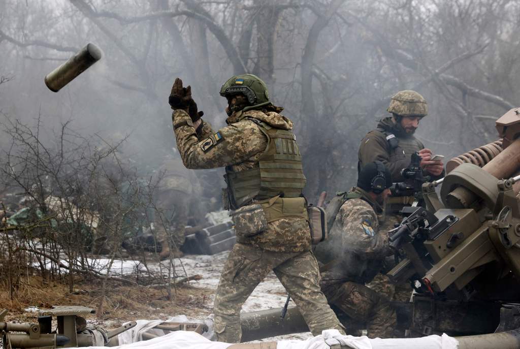 Ukrainian artillerymen fire an L119 howitzer towards Russian positions at a front line in the Lugansk region on Jan. 16, 2023.