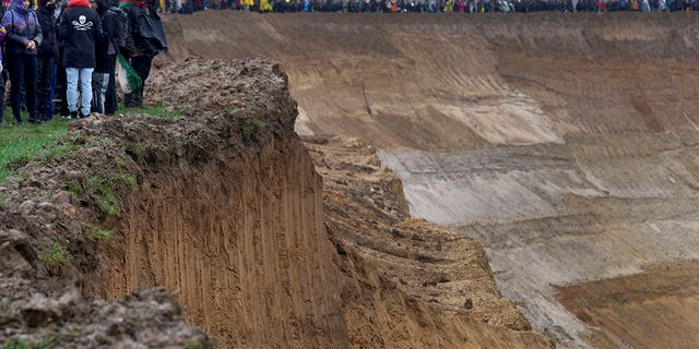 People attend a protest rally at the Garzweiler opencast mining near the village Luetzerath in Erkelenz, Germany, Saturday, Jan. 14, 2023. 