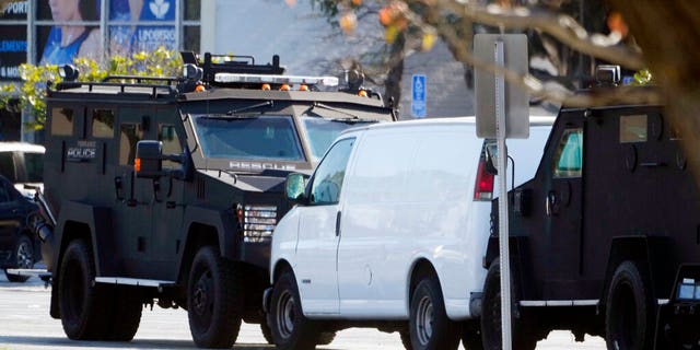 A van is surrounded by SWAT personnel in Torrance Calif., Sunday, Jan. 22, 2023. 