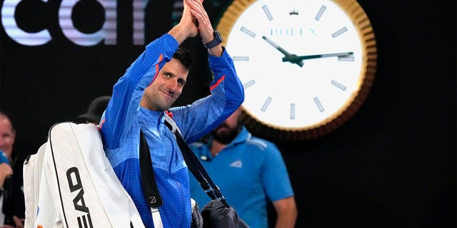 Novak Djokovic of Serbia waves as he leaves Rod Laver Arena after defeating Tommy Paul of the U.S. in their semifinal at the Australian Open tennis championship in Melbourne, Australia, Friday, Jan. 27, 2023. 