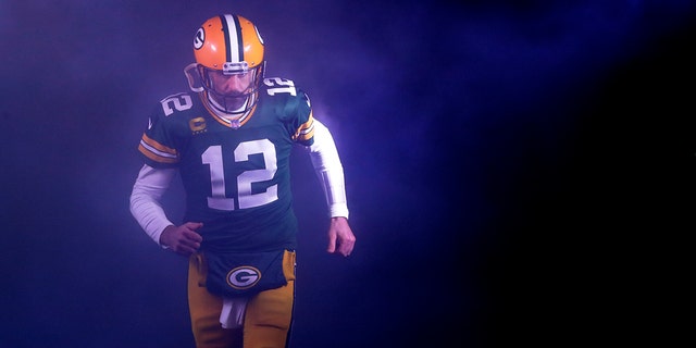 Packers quarterback Aaron Rodgers runs onto the field for the Detroit Lions game at Lambeau Field in Green Bay, Wisconsin, Jan. 8, 2023.