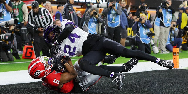 Adonai Mitchell #5 of the Georgia Bulldogs catches a touchdown pass late in the second quarter against Josh Newton #24 of the TCU Horned Frogs in the College Football National Championship game at SoFi Stadium on January 9, 2023, in Inglewood, California.