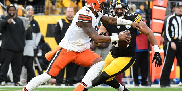 Cleveland Browns quarterback Deshaun Watson scrambles out of the pocket with Pittsburgh Steelers linebacker Alex Highsmith defending during the second half of an NFL football game in Pittsburgh, Sunday, Jan. 8, 2023.