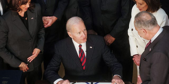 President Biden is flanked by Vice President Kamala Harris, House Speaker Nancy Pelosi and Senate Majority Leader Chuck Schumer as he signs the Consolidated Appropriations Act at the White House, March 15, 2022.