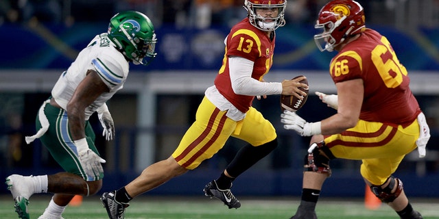 Caleb Williams #13 of the USC Trojans scrambles against the Tulane Green Wave in the second quarter of the Goodyear Cotton Bowl Classic on January 02, 2023 at AT&amp;T Stadium in Arlington, Texas.