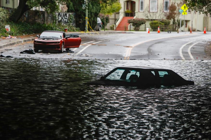 Cars sit stuck in a flooded underpass in Oakland, Calif., on, Jan. 4, 2023.