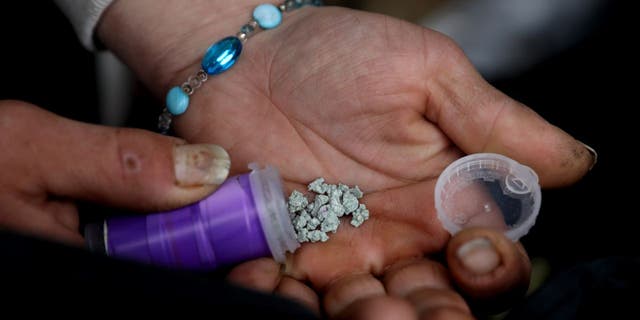  A man shows an eight ball, or 3.5 grams, of fentanyl along East Hastings Street in the Downtown Eastside neighborhood on Tuesday, May 3, 2022 in Vancouver, British Columbia.