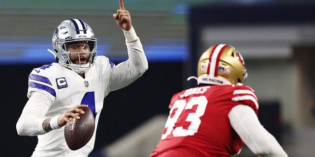 Dak Prescott of the Dallas Cowboys, left, looks to pass against the San Francisco 49ers during the second half of an NFC wild-card playoff game at AT and T Stadium Jan. 16, 2022 in Arlington, Texas.