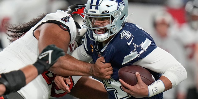 Tampa Bay Buccaneers defensive tackle Vita Vea sacks Dallas Cowboys quarterback Dak Prescott (4) during the first half of an NFL wild-card football game, Monday, Jan. 16, 2023, in Tampa, Fla.