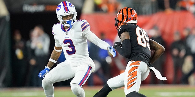 Cincinnati Bengals wide receiver Tee Higgins (85) runs near Buffalo Bills safety Damar Hamlin (3) during the first half of a game Monday, Jan. 2, 2023, in Cincinnati. Hamlin collapsed on the play.