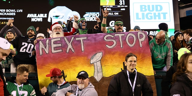 Philadelphia Eagles fans hold signs celebrating the Eagles' win over the San Francisco 49ers in the NFC Championship Game, Jan. 29, 2023, in Philadelphia.