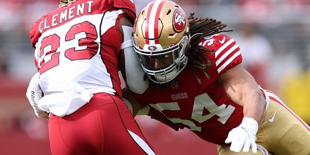 Fred Warner #54 of the San Francisco 49ers tackles Corey Clement #23 of the Arizona Cardinals during the first half at Levi's Stadium on January 08, 2023 in Santa Clara, California.