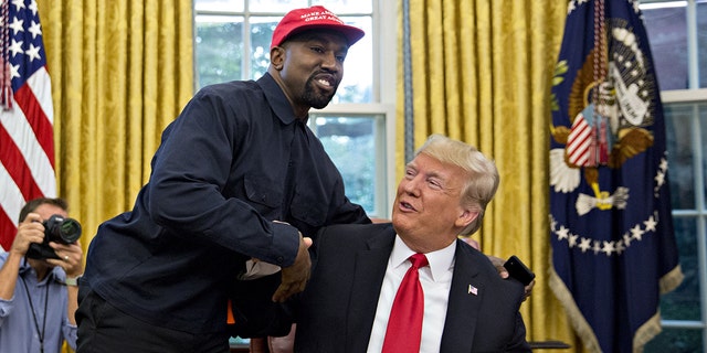 Rapper Kanye West, left, shakes hands with President Trump during a meeting in the Oval Office of the White House in Washington, D.C, Oct. 11, 2018. 