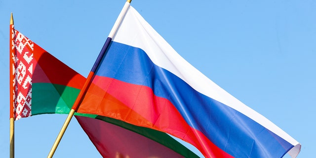 Russian and Belarusian flags wave during a wreath laying ceremony at the Victory Monument. 