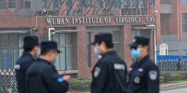 Security personnel stand guard outside the Wuhan Institute of Virology in Wuhan as members of the World Health Organization team investigating the origins of the COVID-19 coronavirus make a visit to the institute in Wuhan in China's central Hubei province on Feb. 3, 2021.